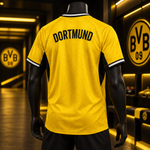 A mannequin wearing a Borussia Dortmund yellow soccer jersey, shown from the back. The jersey features 'DORTMUND' printed in black arched text across the upper back, with black side panels and white trim on the collar and sleeve cuffs.