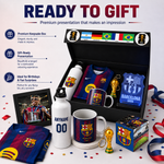 A Barcelona FC-themed gift set displayed in an open black box with promotional text on the left. The set includes a keepsake box, water bottles, mugs, a framed photo, a scarf, a surprise box, and trophy models, all featuring FC Barcelona branding and colors.