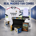 A Real Madrid fan combo gift set displayed in a stadium-style setting, including a white Real Madrid jersey, illuminated acrylic LED night lamp, ceramic mug, presentation box, trophy replica, cube, framed stadium poster, and a white bottle. Text labels identify each item.