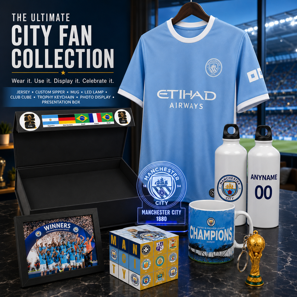 Manchester City FC fan collection display featuring a light blue jersey with Etihad Airways sponsor, a black presentation box with team flags, a framed photo, a blue mug, two white water bottles, a small trophy, and a branded box on a dark marble surface.