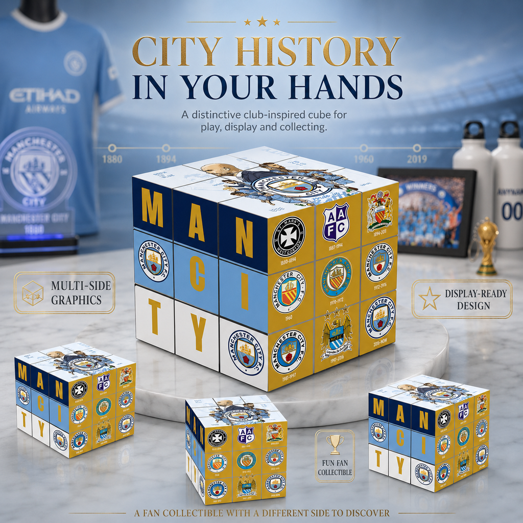A Manchester City-themed cube puzzle set displayed on a marble surface with branded team merchandise in the background. The main product is a large cube showing the word 'MAN CITY' and multiple Manchester City logos, with three smaller cubes around it.