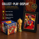 A Spain football-themed collectible display set on a wooden surface, featuring a framed photo of a player holding a trophy, a gold FIFA World Cup trophy keychain, and a branded box. Text on the left reads 'COLLECT • PLAY • DISPLAY' with feature callouts, and a 'Collector's Touch' badge appears in the top right.