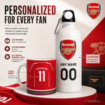 Arsenal personalized gift set featuring a white insulated water bottle and a red ceramic mug with customizable text and number options, displayed on a red and white background with Arsenal branding.