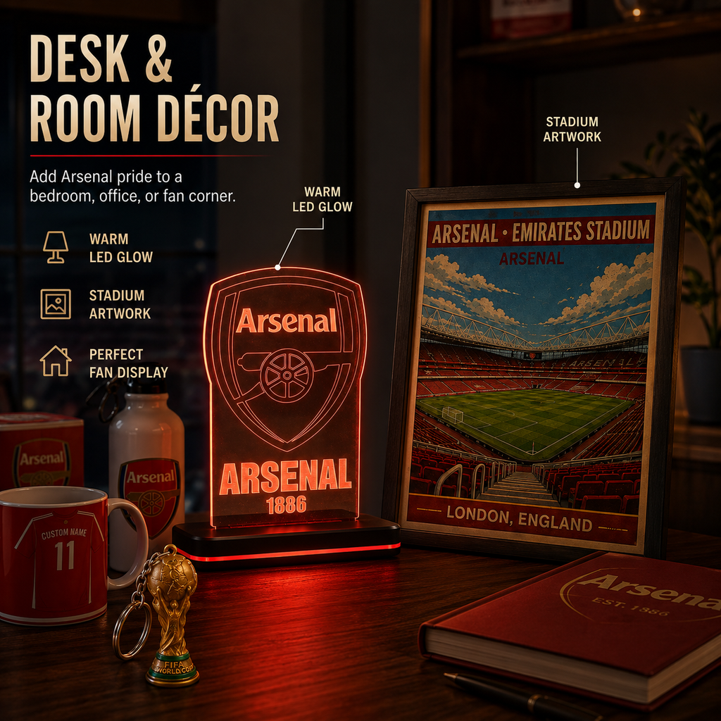 Arsenal-themed desk and room decor set on a dark wooden table, including a glowing acrylic Arsenal crest lamp, framed stadium artwork, a red Arsenal mug, a small trophy keychain, and a red notebook, with promotional text on the left.