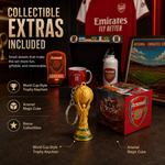 Arsenal collectible extras set on a dark tabletop, featuring a gold FIFA World Cup trophy keychain, a red Arsenal Magic Cube, a Arsenal-branded mug, a white Arsenal water bottle, and a framed poster, with promotional text highlighting included extras.