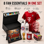 A promotional collage showing a bundle of Bayern Munich fan essentials in a black presentation box: a red striped FC Bayern jersey, a framed players photo, a water bottle, a mug, a trophy keychain, a Rubik's cube, an acrylic LED light, and a display-ready box. Text at the top reads '8 FAN ESSENTIALS IN ONE SET' with feature callouts.