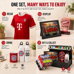 A promotional collage for a Bayern Munich-themed gift set on a light beige tabletop. The set includes a red striped soccer jersey, a framed Champions League trophy display, a glowing neon sign, two customizable water bottles, a red mug, and a gift box with match photos and a small bottle.