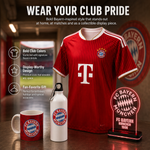 A red and white striped Bayern Munich soccer jersey is displayed on a shelf in a store setting, with a red mug, white water bottle, and illuminated FC Bayern Munich sign in front. Text on the left highlights bold club colors, display-worthy design, and fan favorite gift.