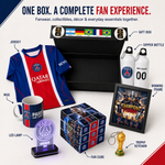 A Paris Saint-Genoese FC one-box fan experience set on a white background, featuring a blue and red jersey, a black gift box, two white bottles, a mug, an LED lamp, a fan cube, a winning frame, and a trophy keychain.