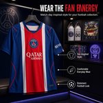 A Paris Saint-Germain football jersey displayed on a hanger in a dark retail-style room. The jersey is blue with a wide red center panel and white vertical stripes, featuring the Paris Saint-Germain crest, Qatar Airways sponsor logo, and Beyo sleeve branding.