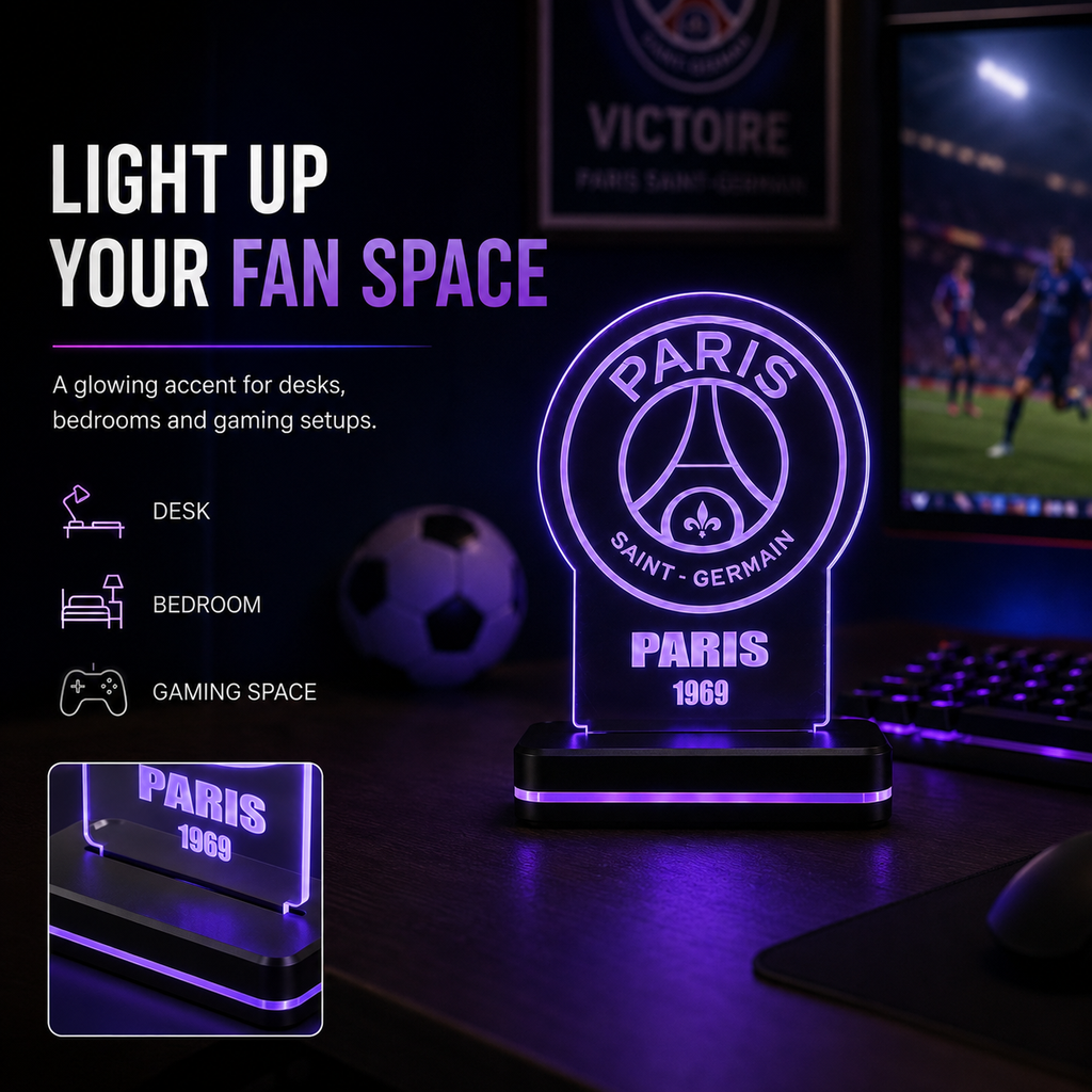 A Paris Saint-Germain illuminated acrylic desk lamp glowing with purple light on a dark desk, with a keyboard, mouse, soccer ball, and a monitor in the background. Text on the left highlights use cases: desk, bedroom, and gaming space.