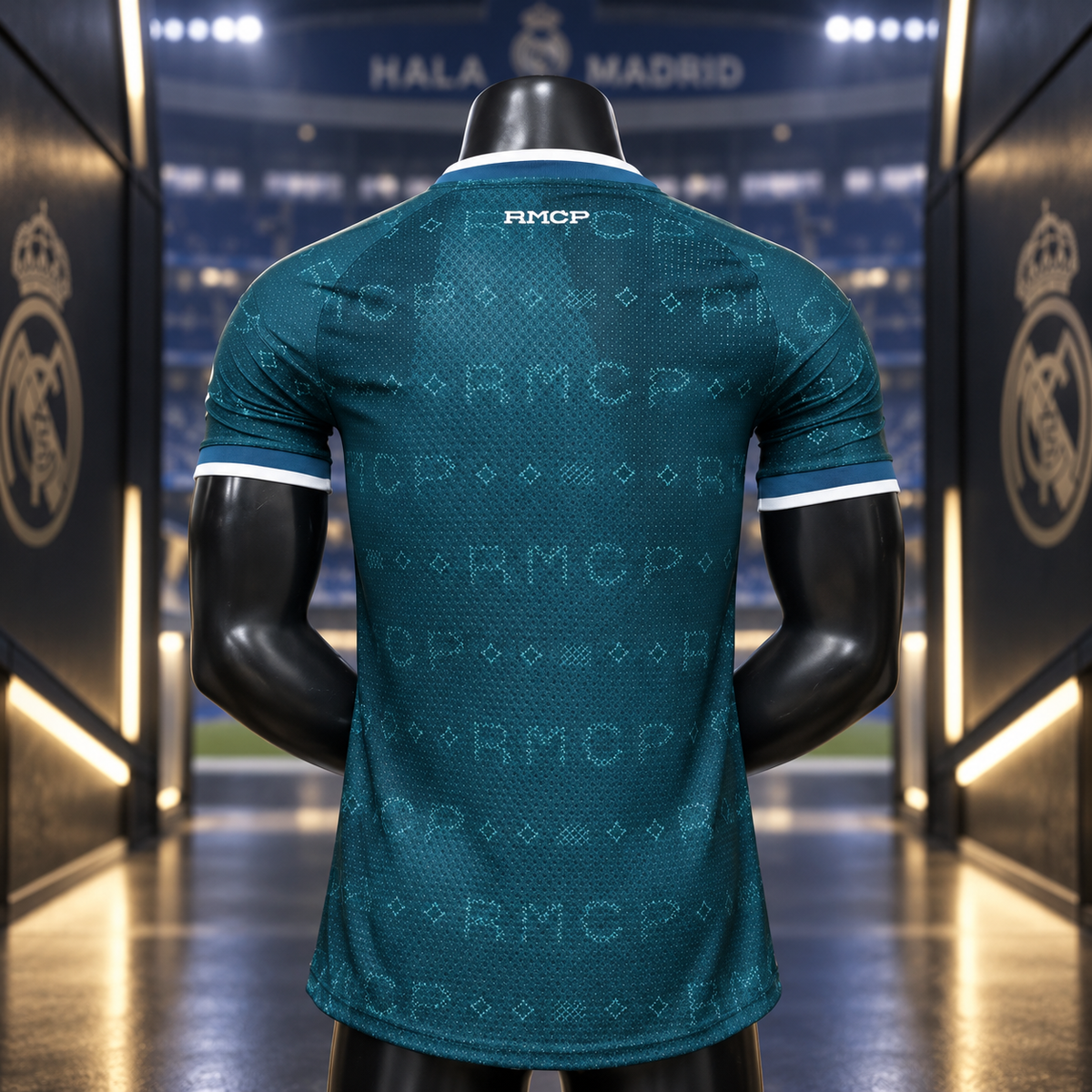 A dark teal Real Madrid soccer jersey with a tonal RMCP monogram pattern, shown from the back on a black mannequin. The jersey features white trim at the collar and sleeve cuffs, and the Real Madrid crest is visible on the background tunnel walls.