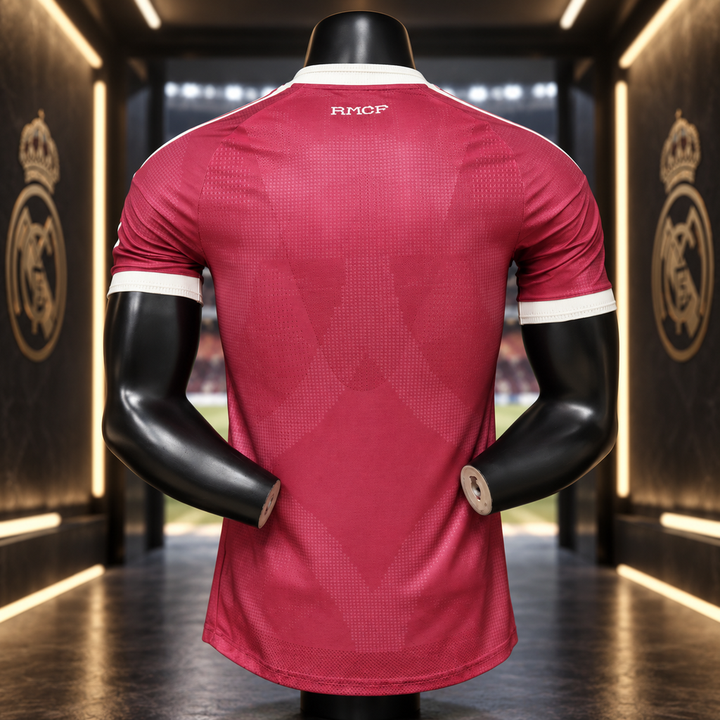 A dark pink Real Madrid soccer jersey shown from the back on a black mannequin torso, with white trim on the collar and sleeve cuffs, and the 'RMCF' logo printed at the neck.