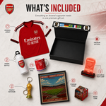 Arsenal supporter gift set infographic showing included items: a red Arsenal jersey, premium gift box, mug, bottle, keychain, framed print, LED lamp, and magic cube on a light background with Arsenal branding.