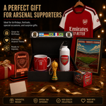 Arsenal-themed gift set arranged on a wooden surface with a black presentation box, red and white football shirt, mug, bottle, framed stadium print, LED light, small trophy, and box, plus promotional text on a dark background.
